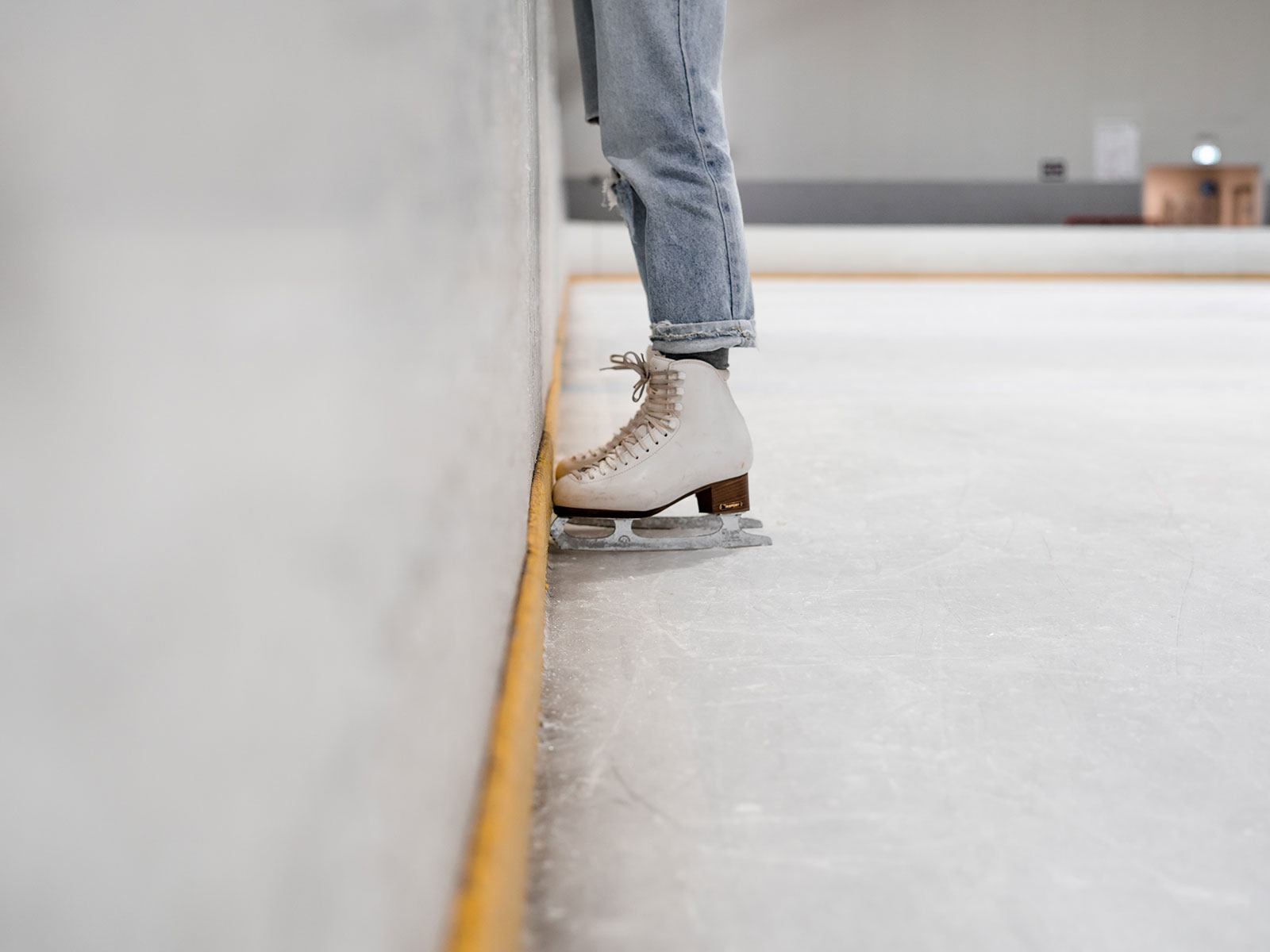 Person wearing ice skates at indoor ice rink