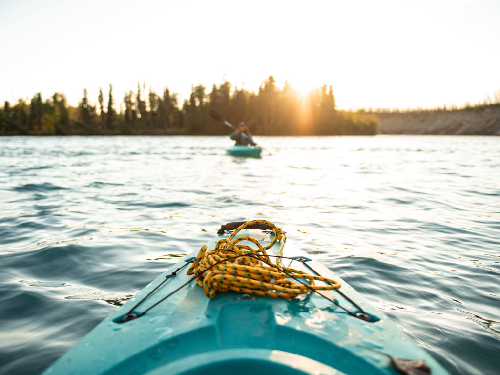 Kayak on lake following another kayak